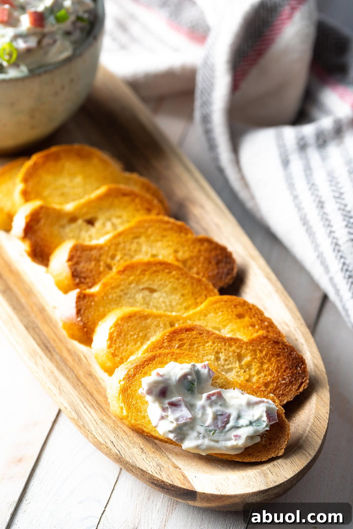 Piece of crostini with a dollop of chipped beef dip on it. 