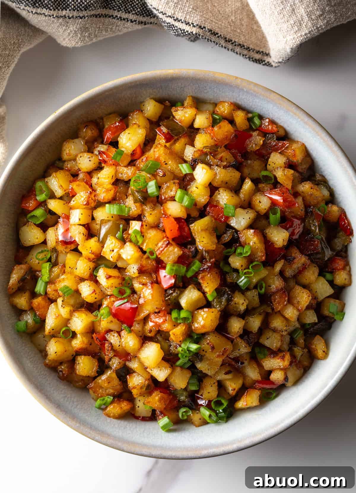 An overhead shot of a bowl of roasted obrien potatoes.