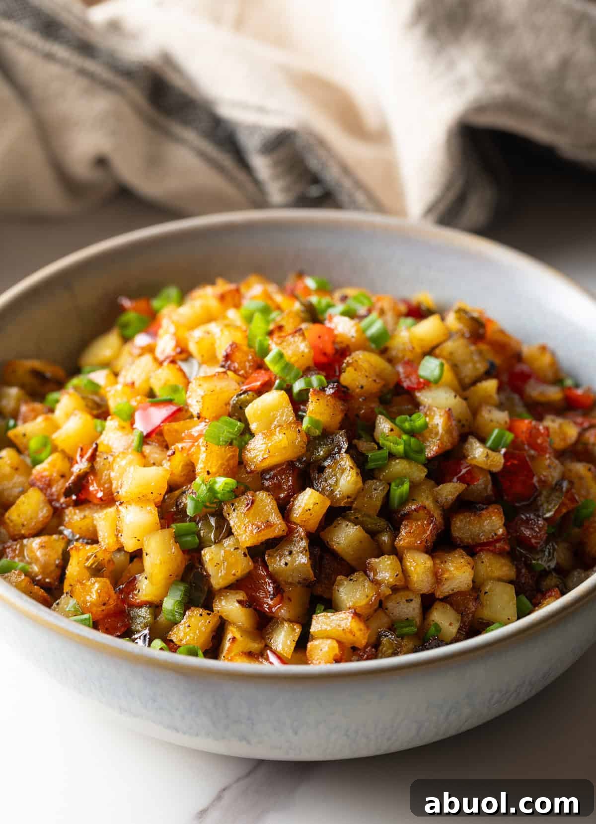 A bowl filled with a homemade potatoes O'brien recipe.